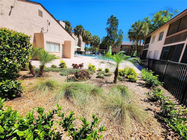 view of yard featuring a community pool and a patio area