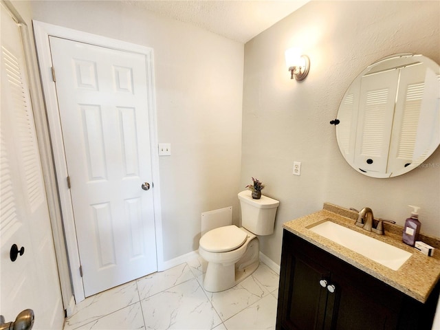 bathroom with vanity, a textured ceiling, and toilet