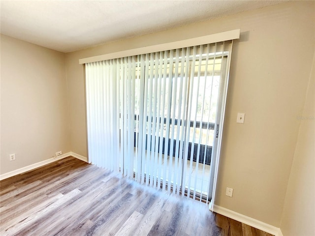 unfurnished room featuring hardwood / wood-style floors