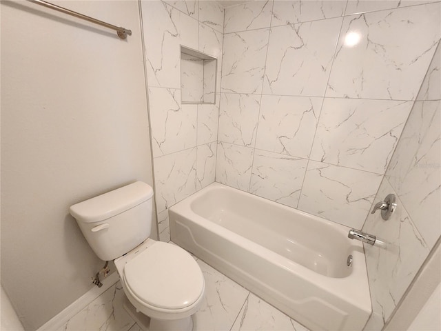 bathroom with tiled shower / bath combo and toilet