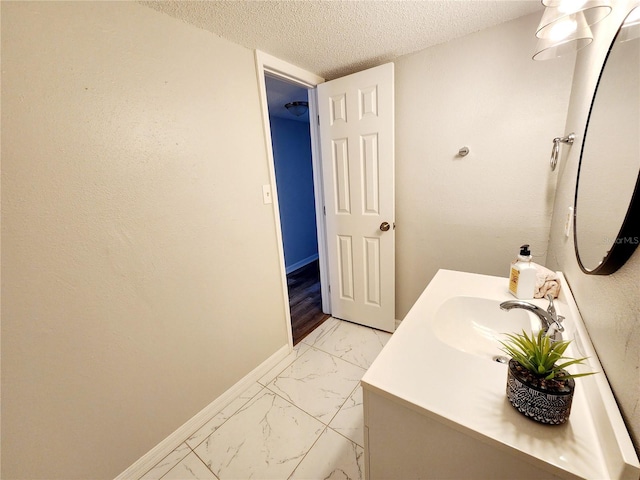 bathroom with vanity and a textured ceiling