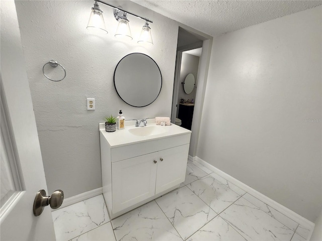 bathroom featuring vanity and a textured ceiling