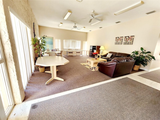 carpeted living room with ceiling fan