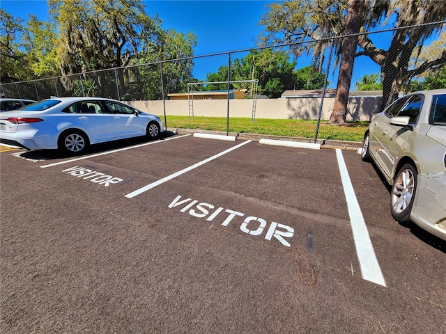 view of car parking with volleyball court