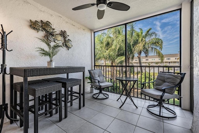 sunroom featuring ceiling fan