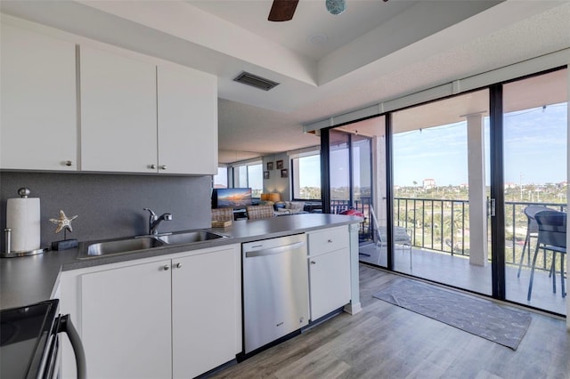 kitchen featuring white cabinetry, appliances with stainless steel finishes, sink, and a wealth of natural light