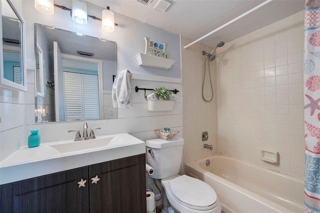 full bathroom featuring vanity, shower / bath combination with curtain, toilet, and wood walls