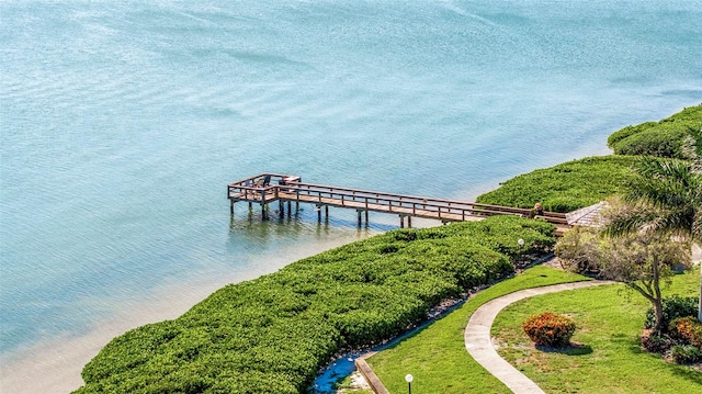 view of dock featuring a water view and a lawn