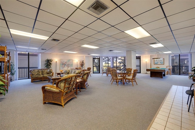 carpeted living room with a paneled ceiling and pool table