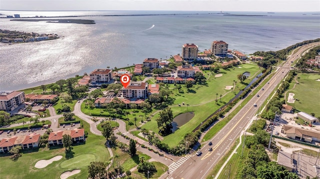 drone / aerial view with a water view and golf course view