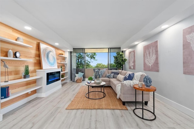 living room with light hardwood / wood-style flooring and a wall of windows