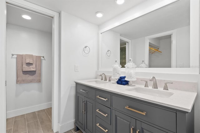 bathroom with oversized vanity and dual sinks