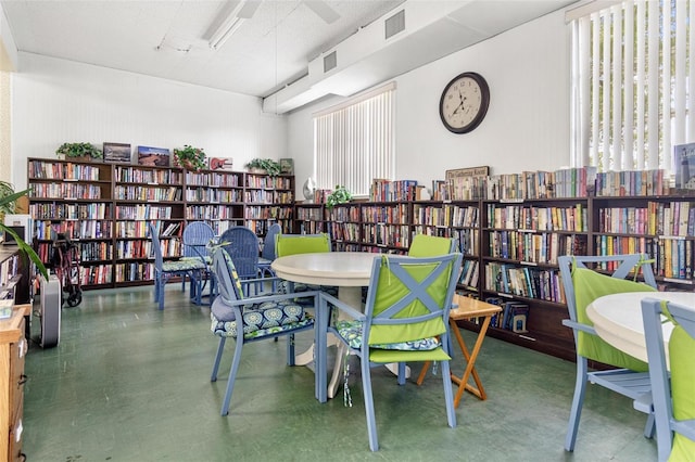 dining room with a textured ceiling and a healthy amount of sunlight