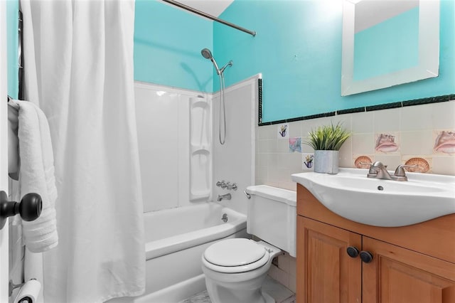 full bath featuring vanity, shower / bath combo with shower curtain, toilet, and tile walls