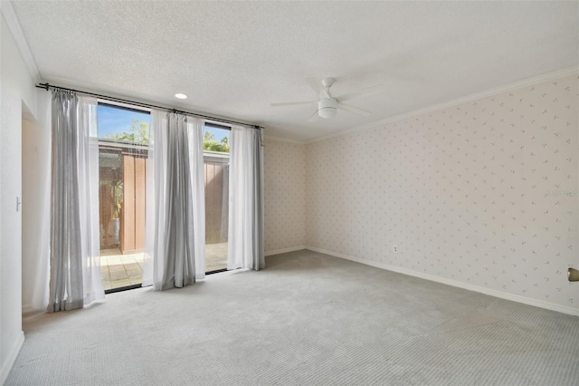 empty room featuring crown molding, ceiling fan, light carpet, and a textured ceiling