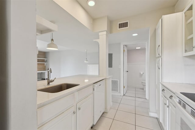 kitchen with white dishwasher, sink, decorative light fixtures, white cabinets, and light tile patterned flooring