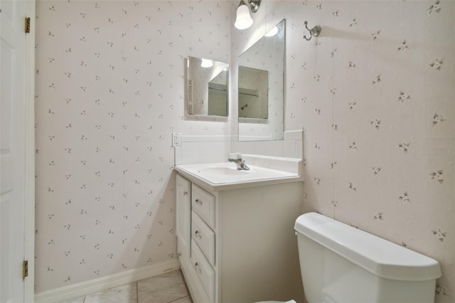 bathroom with tile patterned flooring, vanity, and toilet