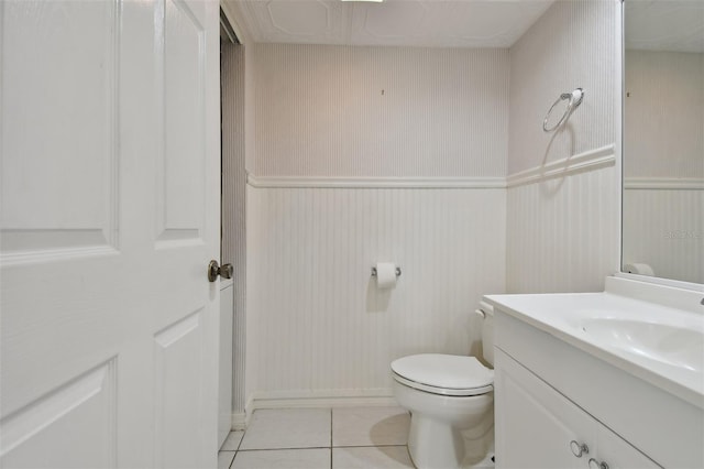 bathroom featuring tile patterned flooring, vanity, and toilet