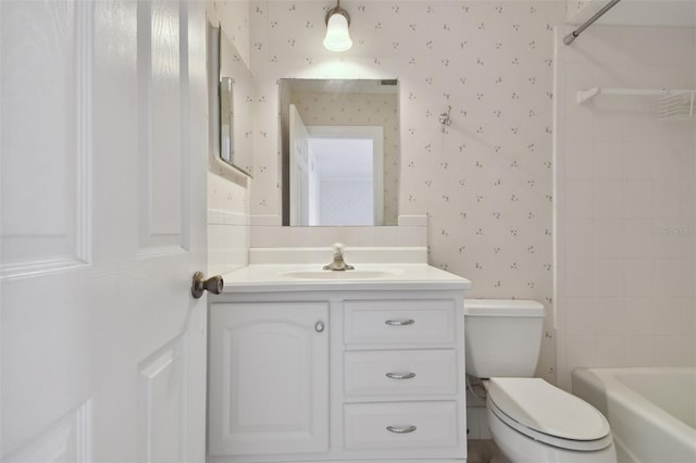 full bathroom featuring vanity, toilet, and tiled shower / bath