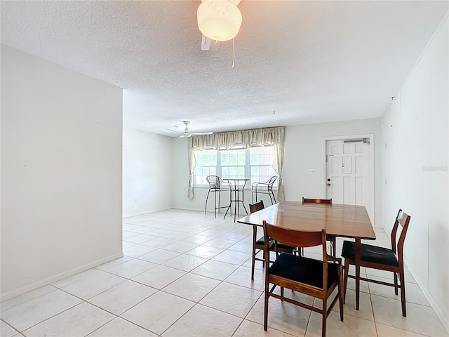 tiled dining room with a textured ceiling