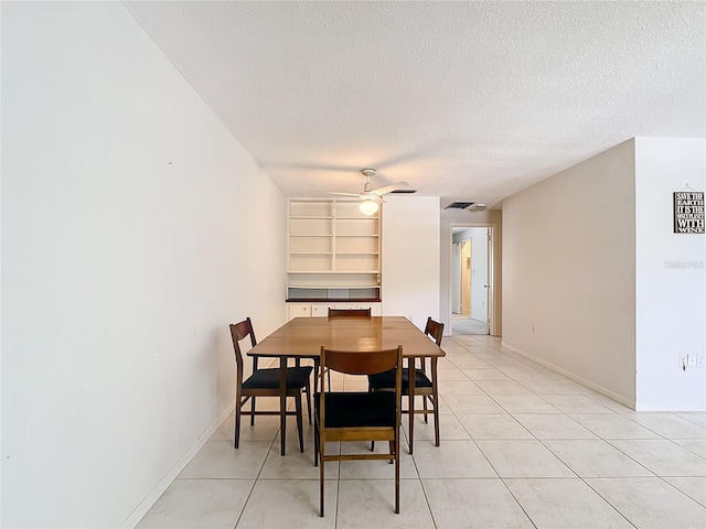 dining room featuring ceiling fan, a textured ceiling, and light tile floors