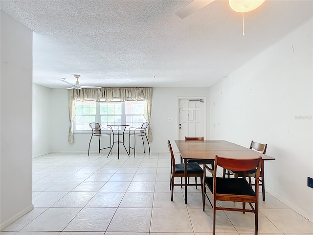 dining room with light tile floors, a textured ceiling, and ceiling fan