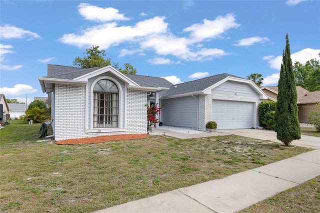 ranch-style home featuring a front lawn and a garage