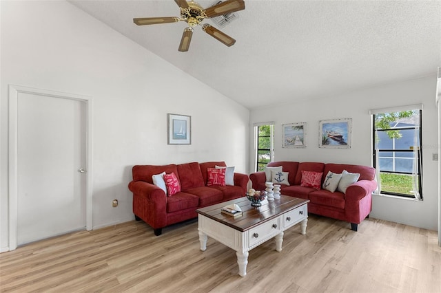 living room with ceiling fan, high vaulted ceiling, light hardwood / wood-style floors, and a textured ceiling