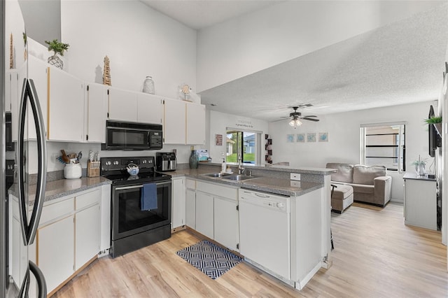 kitchen featuring stainless steel electric range oven, white cabinets, and dishwasher