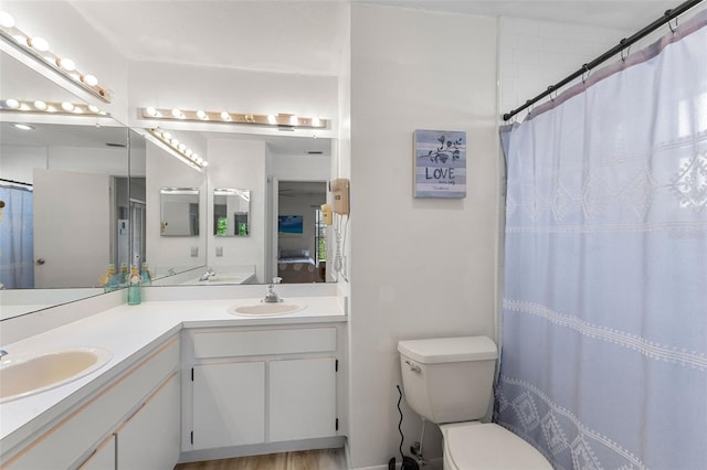 bathroom featuring double sink vanity and toilet