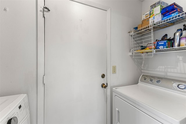 clothes washing area featuring washer and dryer