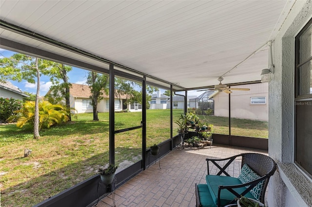 sunroom / solarium featuring ceiling fan