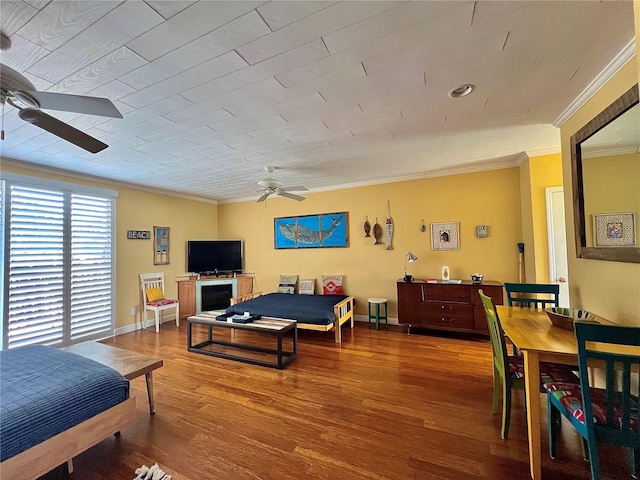 bedroom featuring ornamental molding, wood-type flooring, and ceiling fan