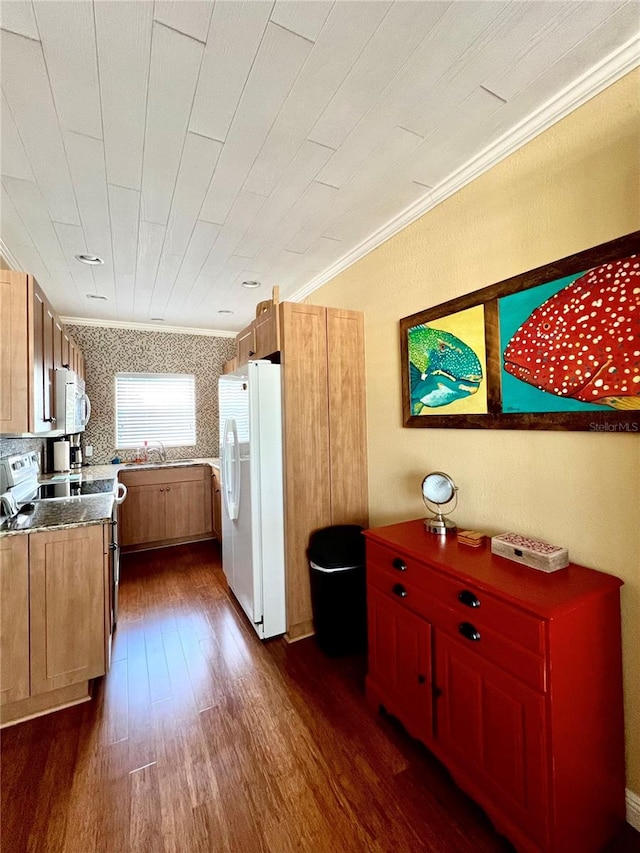 kitchen with sink, white appliances, crown molding, and dark wood-type flooring