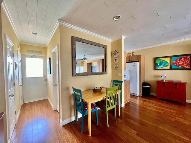 dining space with wood-type flooring, ceiling fan, and crown molding