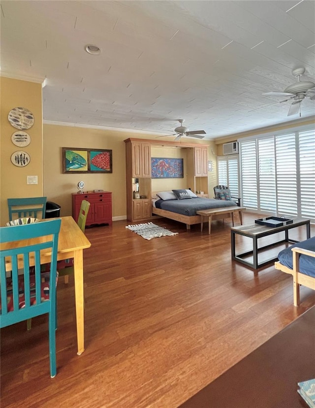 rec room featuring a wall unit AC, ceiling fan, crown molding, and hardwood / wood-style flooring