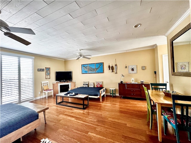 bedroom with hardwood / wood-style flooring, crown molding, and ceiling fan