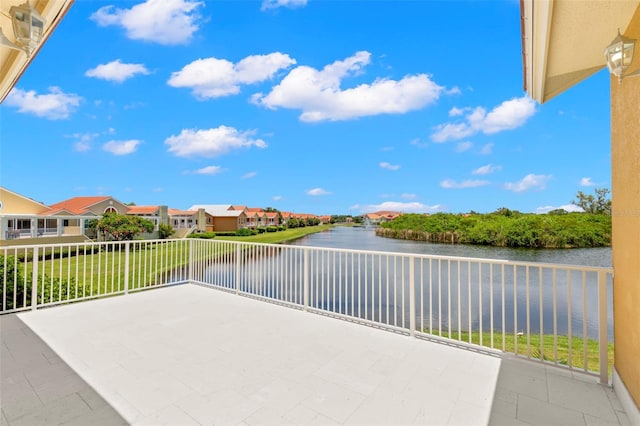 view of patio / terrace with a water view and a balcony