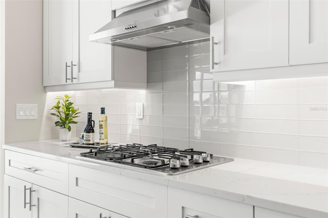 kitchen with white cabinets, stainless steel gas stovetop, and range hood