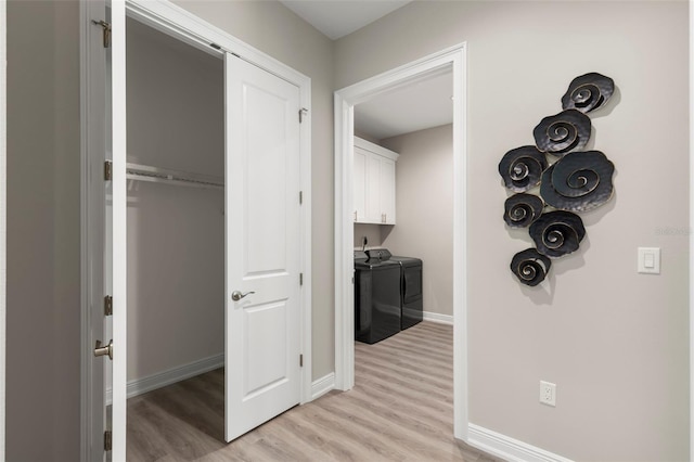 hallway featuring separate washer and dryer and light wood-type flooring