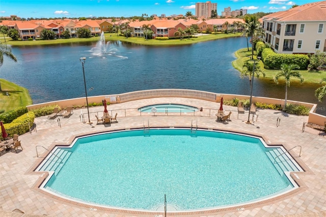 view of swimming pool featuring a water view