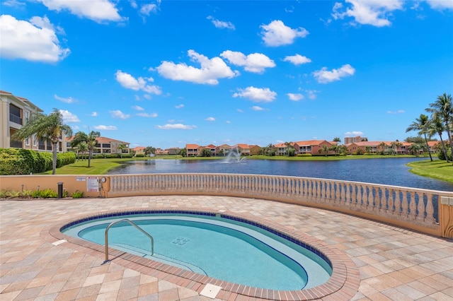 view of swimming pool with a water view