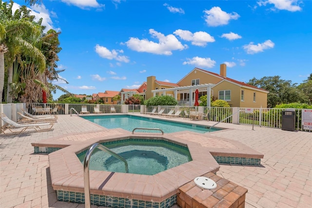 view of swimming pool with a patio area, a hot tub, and a pergola