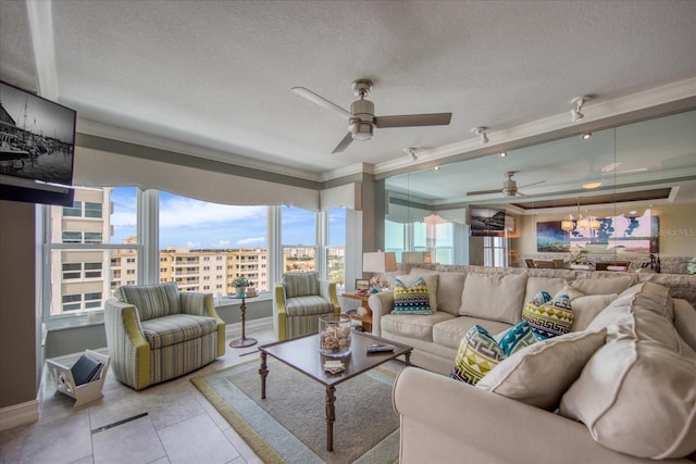 living room featuring crown molding, tile flooring, ceiling fan, and a textured ceiling