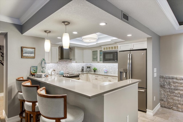 kitchen with hanging light fixtures, white cabinetry, backsplash, appliances with stainless steel finishes, and light tile floors