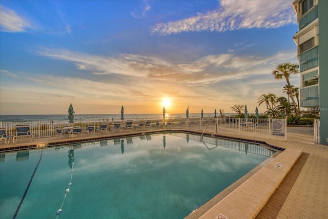 view of pool at dusk