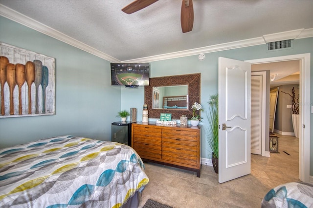 bedroom featuring ornamental molding, tile floors, ceiling fan, and a textured ceiling