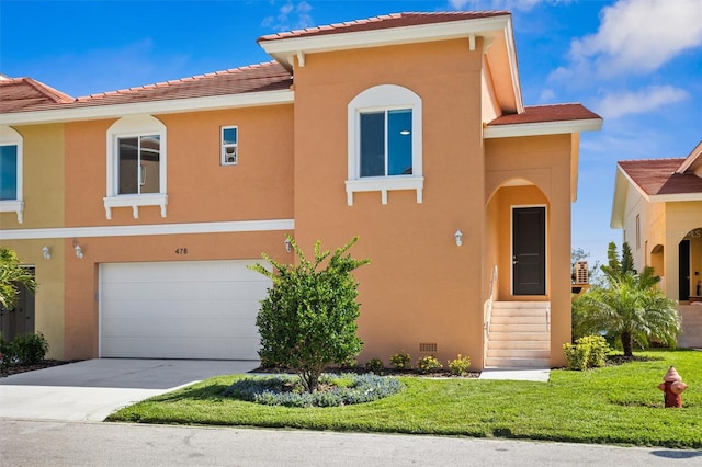 view of front facade with a garage and a front lawn