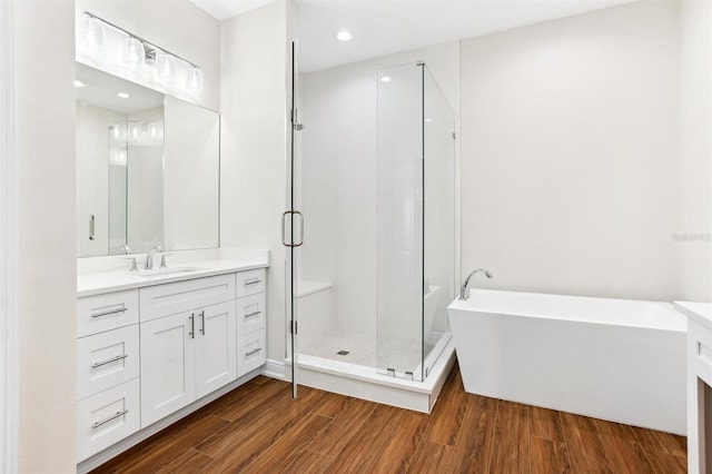 bathroom featuring shower with separate bathtub, vanity, and hardwood / wood-style floors