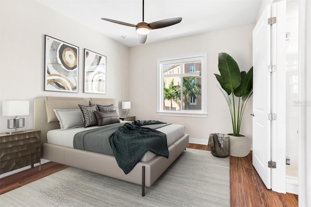 bedroom with ceiling fan and hardwood / wood-style flooring